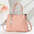 Pink lychee texture crossbody bag with silver hardware and elegant pearl chain ornament - Pink