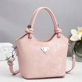 Retro pale pink bucket bag with knotted handles and metallic triangle detail - Pink