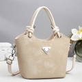 Retro beige bucket bag with triangular metal logo and knotted handle for crossbody use - Apricot