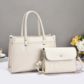 Detail view of cream leather tote bag and crossbody pouch set with pebble texture - Two-Piece Set / Off-white