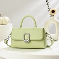 Retro light green crossbody bag with silver buckle and top handle on a white display - Green