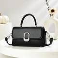Classic black leather crossbody bag with silver oval buckle on a minimalist white display - Black