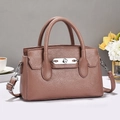 Close-up of litchi texture leather and elegant silver twist lock on pink crossbody bag - Pink