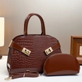 Detail of dark brown crocodile embossed tote and pouch with golden geometric hardware - Coffee
