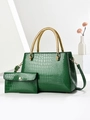 Detail of green crocodile texture tote bag with golden woven handles and small matching purse - Green
