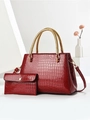Macro detail of dark red crocodile embossed faux leather with gold woven metal handles - Wine Red