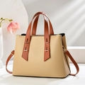 Minimalist beige pebble leather handbag with brown straps and gold hardware details - Khaki