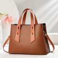 Close-up of caramel lychee texture leather handbag with gold metal hardware - Khaki/Earth Yellow