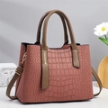 Elegant mauve crocodile pattern handbag with top handle and gold-tone metal hardware - Pink