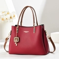 Red lychee pattern tote bag with brown handles and a cute gold bear charm detail - Burgundy