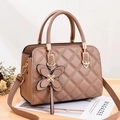 Stylish tan quilted crossbody bag with gold hardware and butterfly charm accessory - Khaki