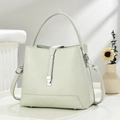 Detailed view of mint green pebble leather bucket bag with silver metal buckle and handle - Gray