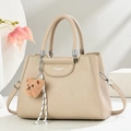 Elegant beige lychee texture leather tote bag with plush bear charm and crossbody strap - Khaki