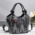 Chic silver sequin bucket bag with knotted black leather handles and star charm - Black