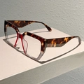 Detail view of square tortoiseshell and transparent frame glasses from a 45-degree angle - Red Gray Leopard Frame Clear Lens