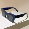 Detail of dark blue matte sunglasses featuring silver metal accents and wide temples - Blue Frame Grey Lens