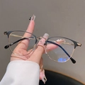Detailed close-up of stylish black and gold half-rim glasses with premium metal temples - Matte Black Frame Transparent Lens