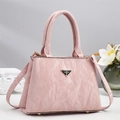 Detail of light pink wrinkled faux leather handbag with triangle logo and gold studs - Pink