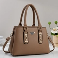 Brown lychee leather tote bag with top handles and triangular metal detail on gray background - Khaki