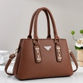 Detailed close-up of dark brown lychee pattern leather tote with silver metal hardware - Khaki/Earth Yellow