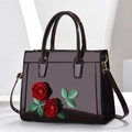 Glossy black patent leather tote bag with 3D red rose floral appliqué and gold hardware - Brown
