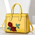 Elegant yellow patent leather handbag with red rose 3D applique and gold hardware details - Yellow
