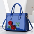 Blue patent leather handbag with red rose floral applique and round handles - Blue