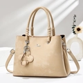 Retro khaki tote bag with top handle and floral charm on a minimal shadow background - Khaki