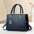 Elegant navy blue handbag with gold hardware and a pearl heart charm on a clean background - L25 H19 W12 / Blue