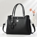 Elegant black lychee texture handbag with silver butterfly charm and shoulder strap - Black