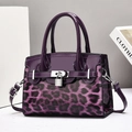 Fashionable purple leopard print handbag with glossy finish and silver metal lock - Purple