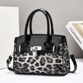 Chic leopard print handbag with black patent leather trim and metal clasp closure - Black