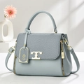 Light blue pebbled leather handbag for women with gold T-logo buckle and top handle - Blue