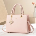 Pink luxury leather handbag with gold heart pendant and adjustable shoulder strap - L25 H19 W12 / Pink