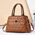 Detail of brown quilted leather handbag featuring rhombic stitching and triangle plaque - Khaki/Earth Yellow