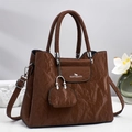 Brown faux leather handbag with pleated texture and round handle including a mini charm bag - Coffee