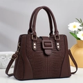 Dark brown leather tote bag with crocodile texture and golden hardware in elegant setting - Coffee