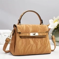 Detail shot of camel brown textured leather handbag with gold metal twist lock and handle - Khaki/Earth Yellow