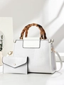 Detail showing white crocodile texture and vintage bamboo handles on a large shoulder bag - White