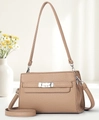 Detail of light brown lychee grain leather handbag with silver clasp in a bright interior - Dark Khaki
