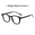 Occhiali rotondi TR90 nero lucido con borchie a diamante argento su sfondo bianco - Montatura nero lucido