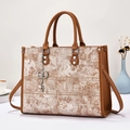Elegant embroidered tote bag with floral jacquard patterns and brown leather handles - Earthy Yellow