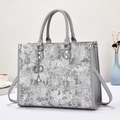 Detail of grey embroidery tote bag with heart charm and pearl decoration - Gray