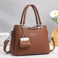 Braune Handtasche für Damen in Lederoptik mit silbernen Details und Taschenanhänger - Erdgelb