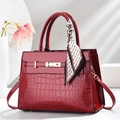Elegant wine red crocodile-embossed handbag with gold hardware and silk scarf detail - Wine Red