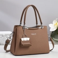 Brown woven crossbody bag with leather handle and white text on minimalist background - Brown