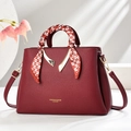 Close-up of wine red litchi grain leather bag with decorative silk scarf on handle - Wine Red