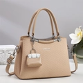 Close-up of khaki woven handbag with silver metal hardware and branded charm detail - Khaki