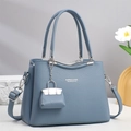 Elegant grey-blue leather handbag for middle-aged women with pebble texture and mini charm - Blue
