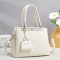 Elegant off-white lychee texture handbag with metal bar detail and mini pouch pendant - Off-white